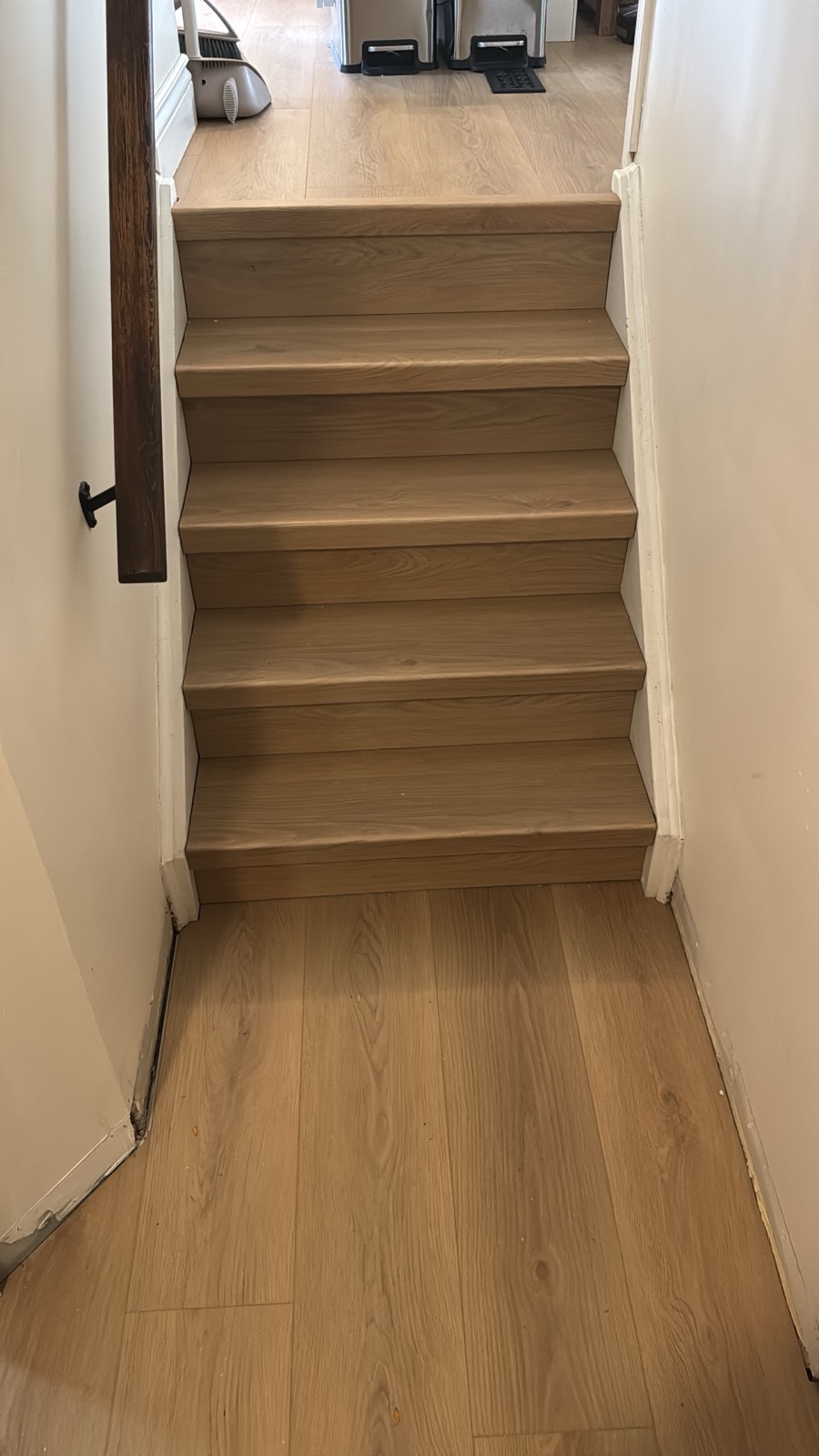 Staircase with new oak-look treads and risers matching the hallway floor